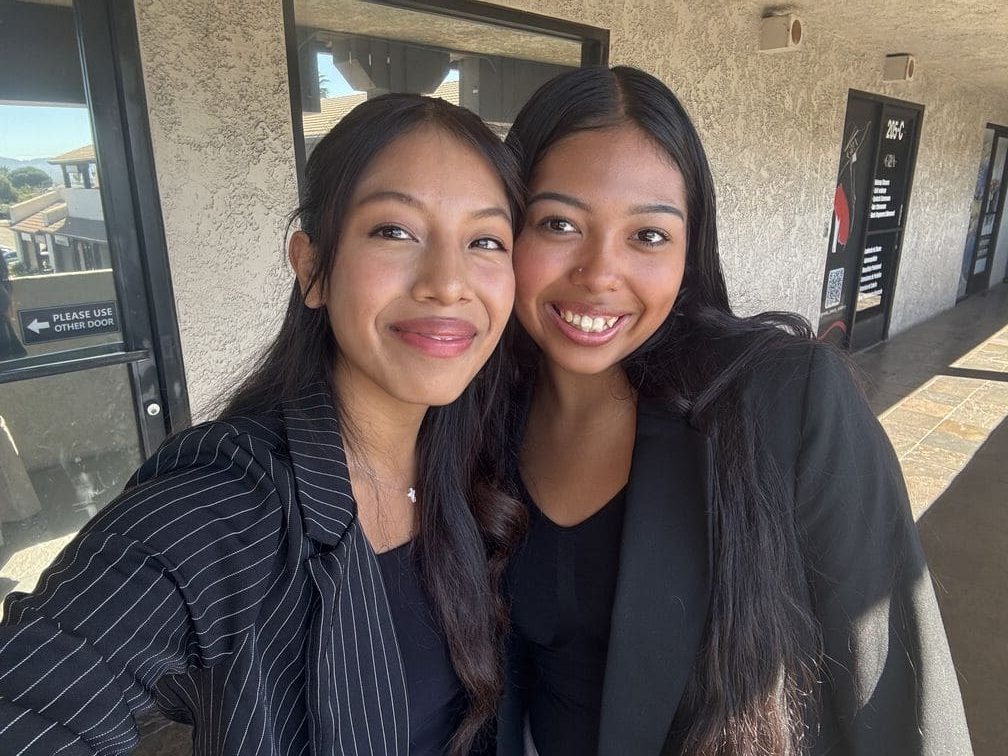 F3 Innovations team members in striped blazer smiling outside office 205-C